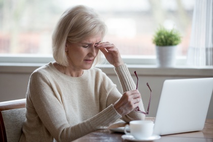 Grieving woman at her laptop