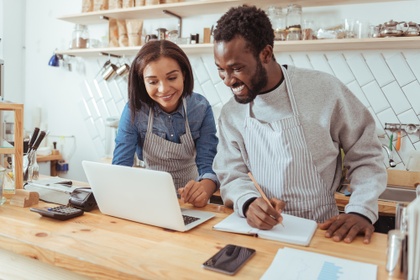 self employed couple looking at laptop