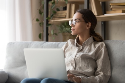 woman on laptop thinking