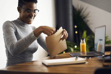 Woman opening a brown envelope