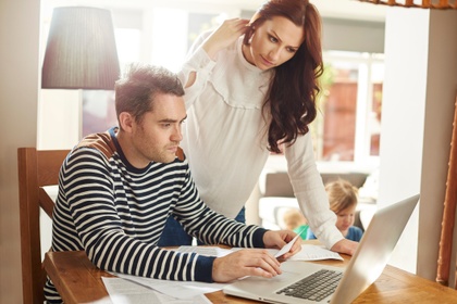 A man and a woman looking at a laptop