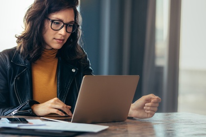 woman researching on laptop