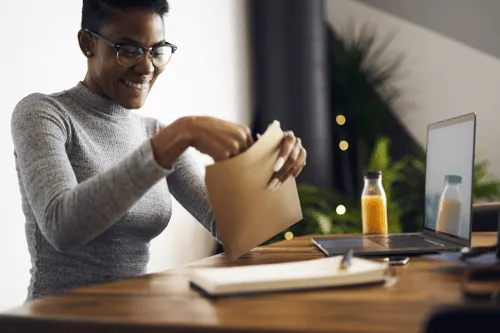 Woman opening a brown envelope