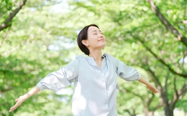 Woman in woods breathing