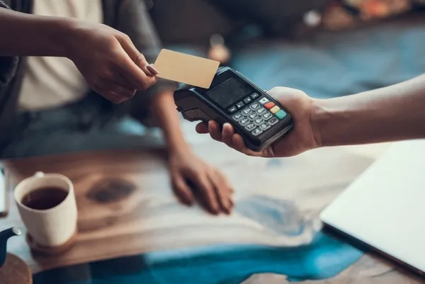Person using a credit card to make a contactless payment