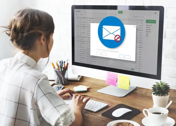 woman looking at her emails on her computer