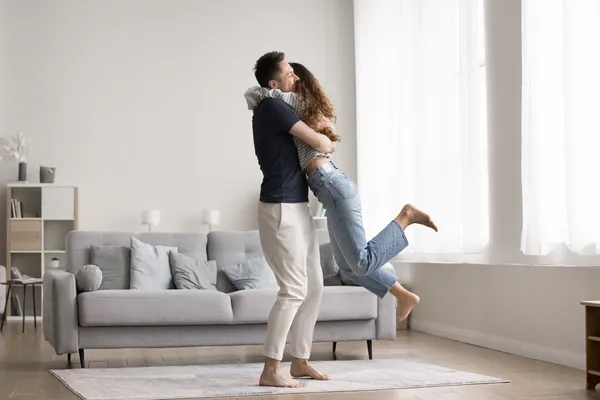 Couple celebrating in living room