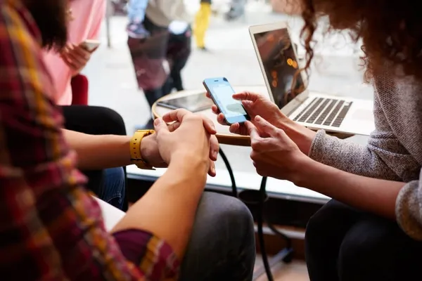 People looking at a mobile phone