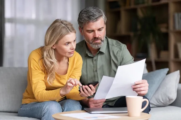 Couple looking at their finances at the dining table