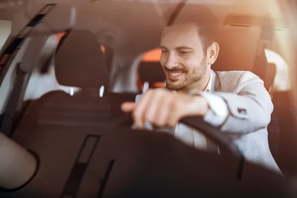 Man driving his new car