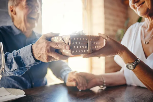 Senior couple exchange a gift