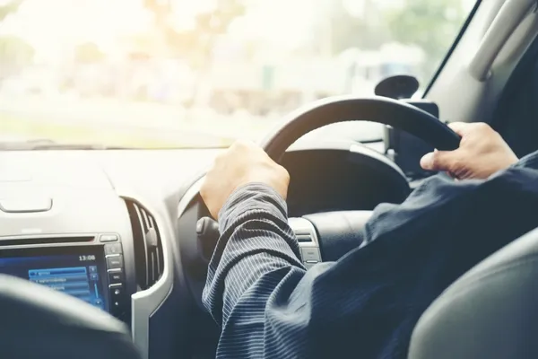 man driving car