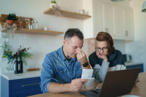 stressed couple looking at finances