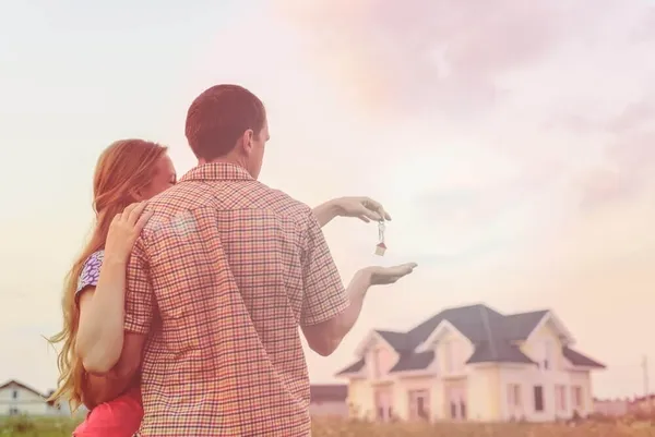 Couple with keys to new house