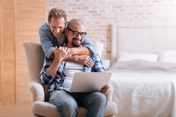 two men looking at laptop