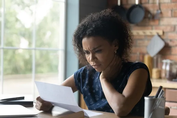 Woman reading letter from a debt collection agency