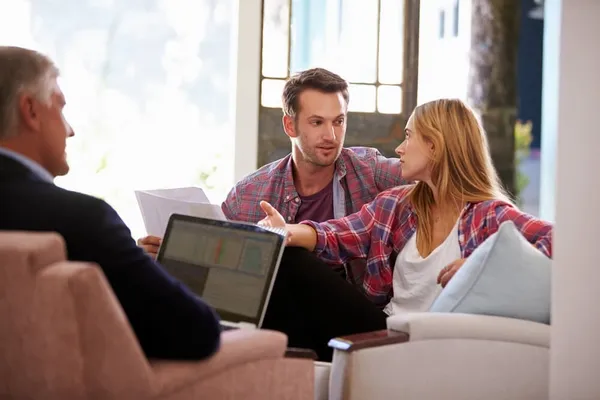 Couple speaking to a broker