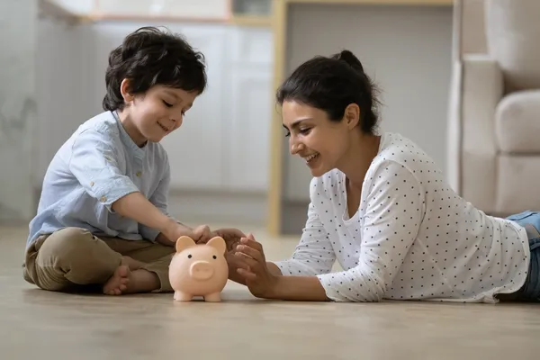 Parent and child with piggy bank