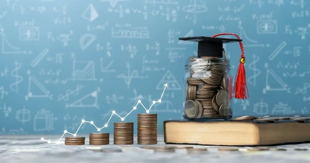 Jar of coins with a student graduation hat on