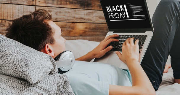 Man shopping on his laptop for Black Friday deals