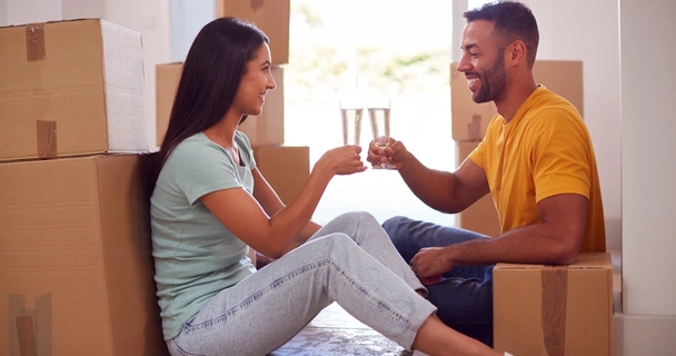 first time buyers toasting to their new home surrounded by boxes