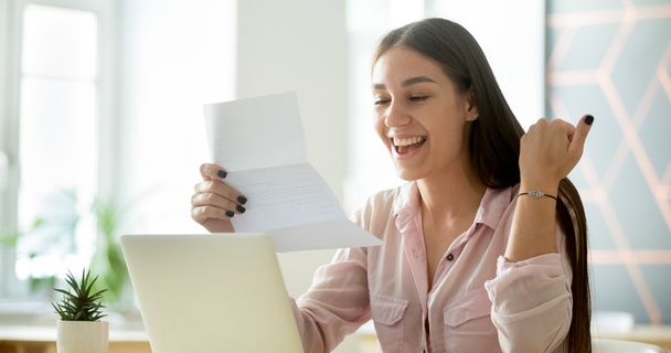 excited woman at desk