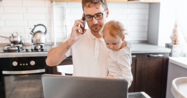 man on phone with small child