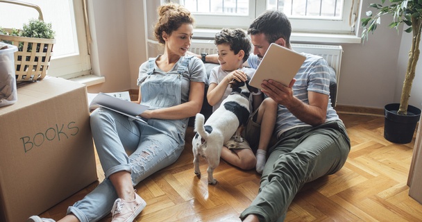 Happy family in new home sitting together on the floor