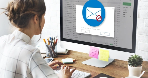 woman looking at her emails on her computer