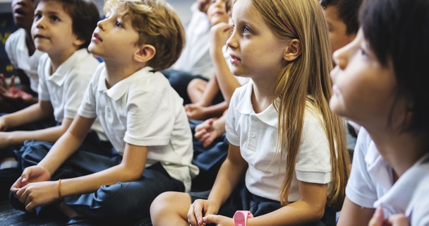 school kids listening to teacher