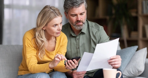 Couple looking at their finances at the dining table