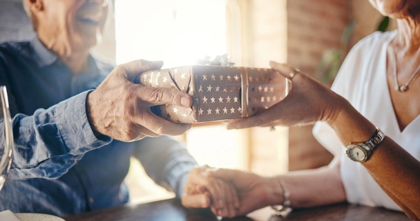 Senior couple exchange a gift