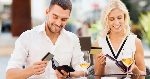 Man and woman looking at their bank cards