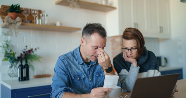 stressed couple looking at finances