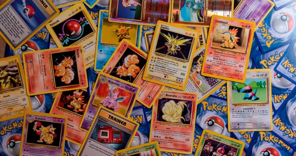 Hand holding rare Pokémon cards