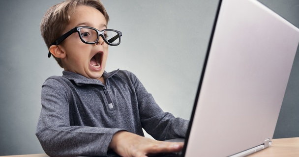 Person looking shocked at their computer