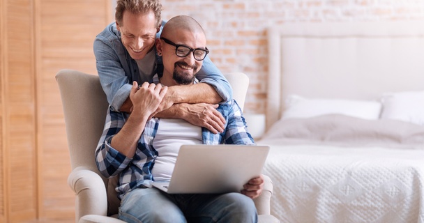 two men looking at laptop