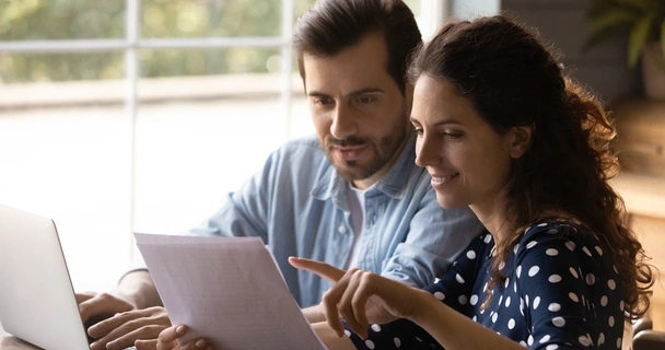 happy couple looking at paperwork together