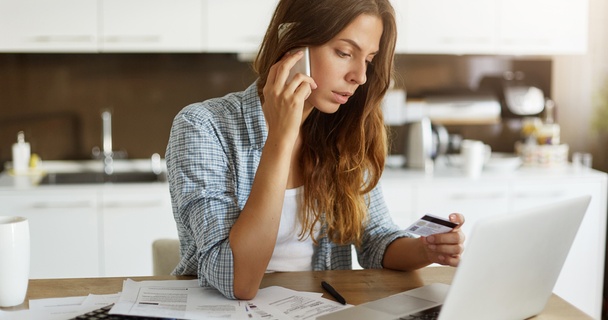 woman on phone with credit card