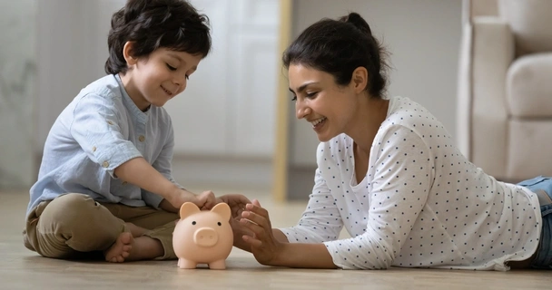 Parent and child with piggy bank