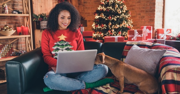 Woman online shopping with a Christmas jumper on