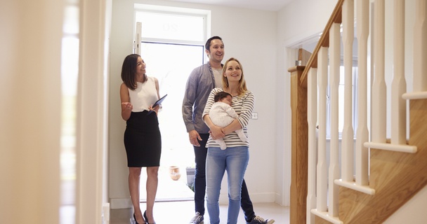 Young family being shown around a new home