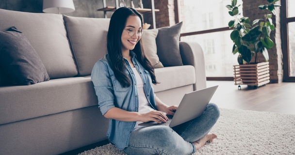 woman checking on laptop in lounge