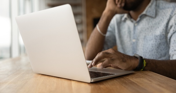 Man typing on a laptop