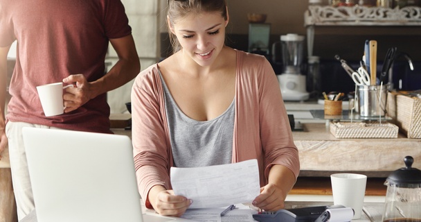 Couple looking at documents in their kitchen