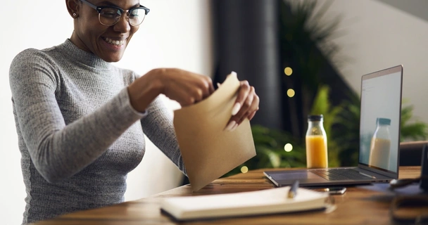 woman putting a letter into an envelope