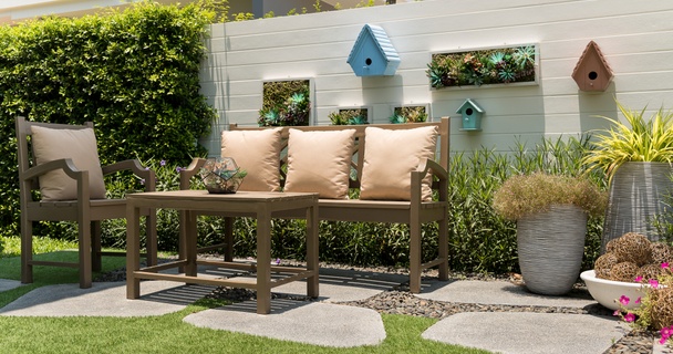 cosy corner of a small garden with painted wall and outdoor furniture