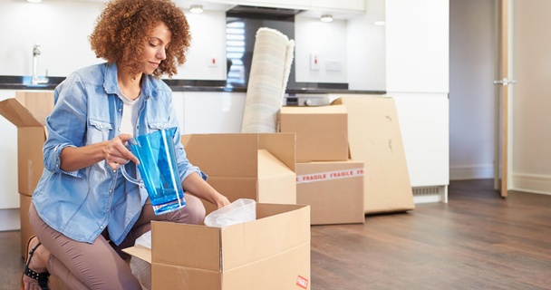 Person packing items away to move house