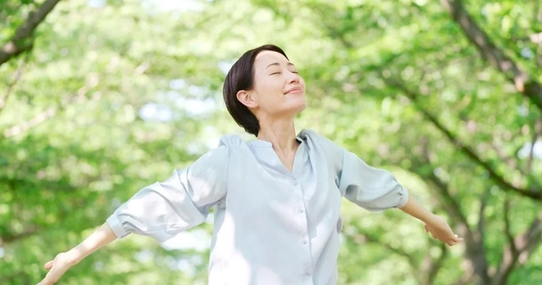 Woman in woods breathing