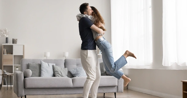 Couple celebrating in living room